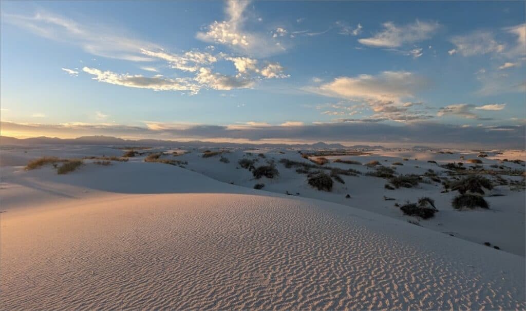 A sandy hills with a white sands and a blue sky at White Sands National Park