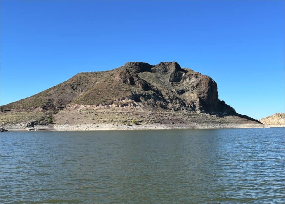 The Elephant Butte in the middle of a body of water at Elephant Butte Lake.