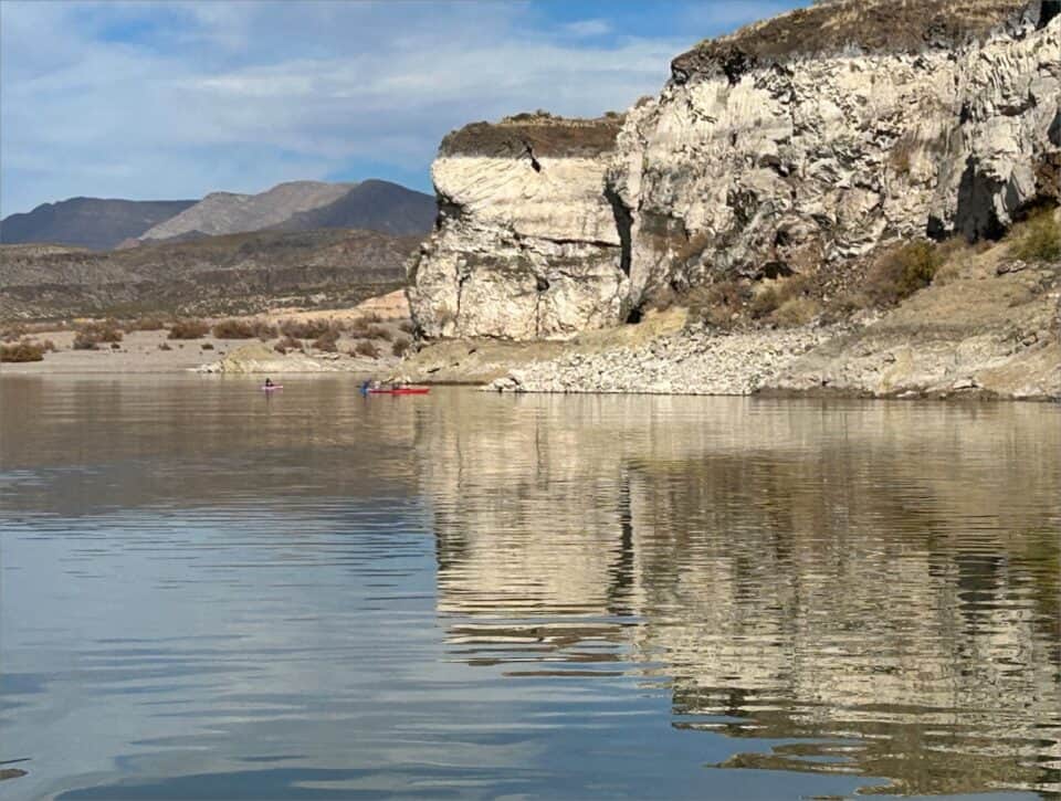 A kayaker is paddling in the water at Elephant Butte Lake.