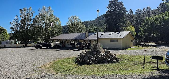 A building at Twin Spruce RV Park with a pile of rocks in front of it.